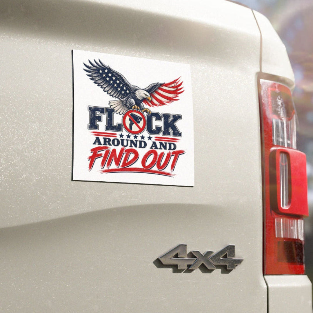 A square white sticker with a patriotic eagle graphic and the text 'FLOCK AROUND AND FIND OUT' in blue and red, shown applied to the rear side of a beige 4x4 truck outdoors.