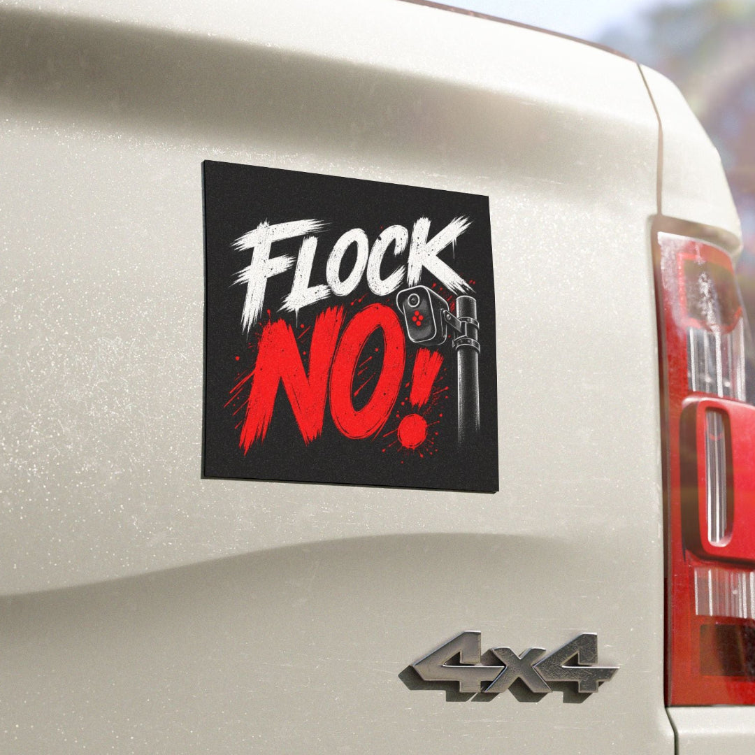 A square black sticker with the text 'FLOCK NO!' in white and red brush-style lettering, shown applied to the rear side of a white vehicle. The sticker includes a small wrench graphic and is photographed outdoors with a blurred background.